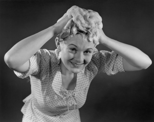 PORTRAIT OF YOUNG WOMAN WASHING HAIR (Photo credit: Bettmann / Contributor)
