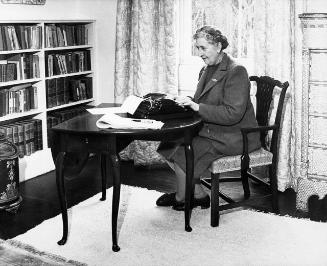 Agatha Christie sitting before a typewriter