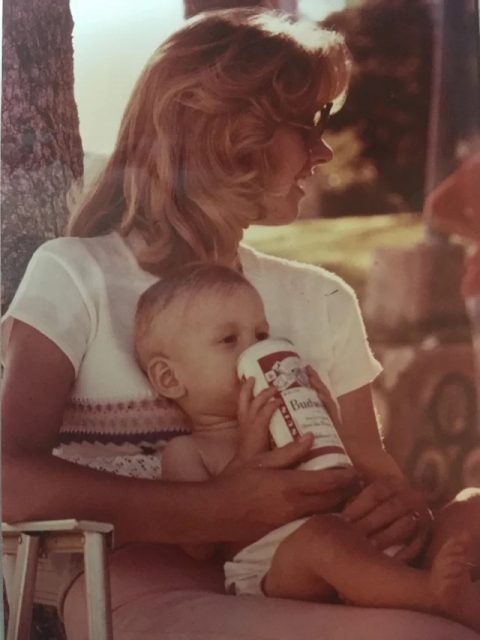Baby drinking a Budweiser 