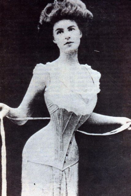Woman cinching her corset