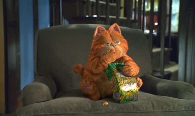 Garfield eating Goldfish crackers on the couch