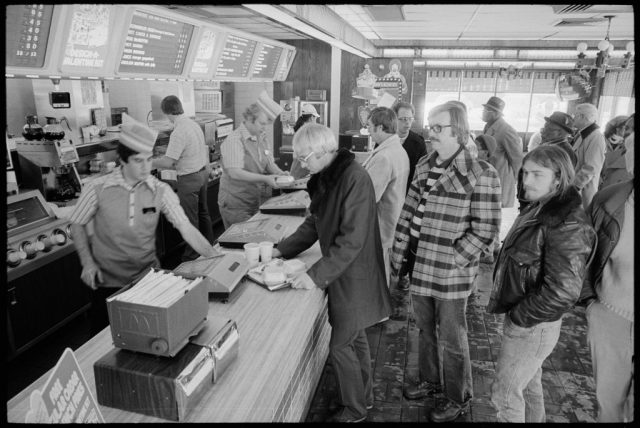 Customers lining up at the front counter in a McDonald's restaurant