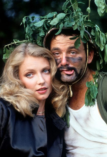 Cindy Morgan and Bill Murray nestled behind a tree in a scene from the film ‘Caddyshack’, 1980. (Photo Credit: Orion Pictures/Getty Images)