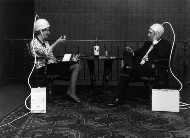 A couple raise a toast to their own indulgence as they enjoy the luxurious pleasures of an air turbo head massaging machine. (Photo Credit: Carlo Polito/Getty Images)