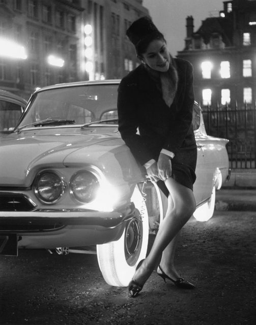 A woman adjusts her stocking by the light of the new Goodyear illuminated tires.  (Photo Credit: Douglas Miller/Getty Images)