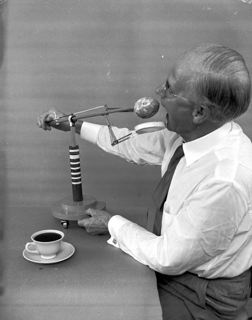 Russell E Oakes demonstrates his doughnut dunker. (Photo Credit: Evans/Getty Images)