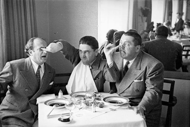 circa 1939: American comedian Moe Howard poking his fellow comedians Larry Fine (left) in the eye while sticking a finger up the nose of Curly Howard. (Photo Credit: Fox Photos/Getty Images)