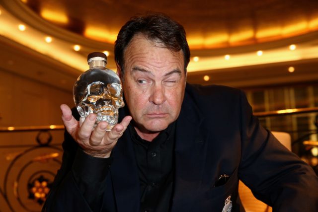 Dan Aykroyd poses with a bottle of ‘Crystal Head’ vodka (Photo Credit: Mathis Wienand/Getty Images)