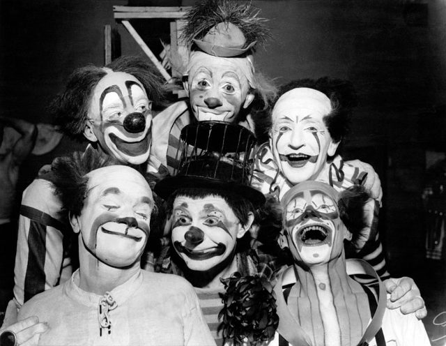Six clowns posing for a picture