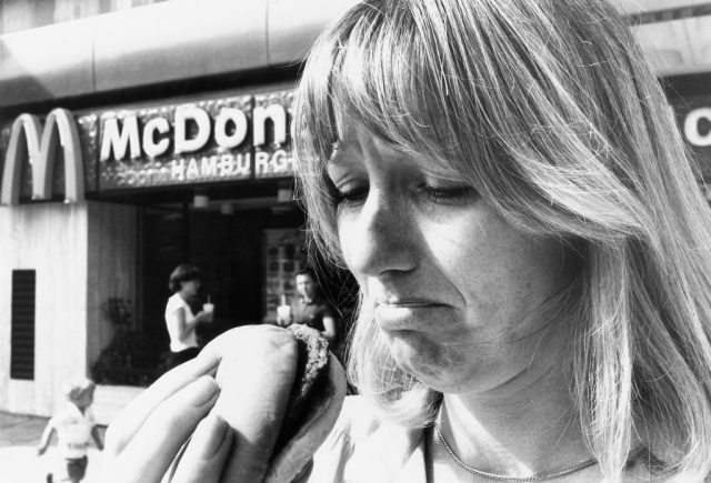 Woman looking doubtfully at a Big Mac