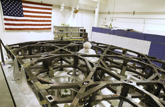 Scientist standing within a metal frame