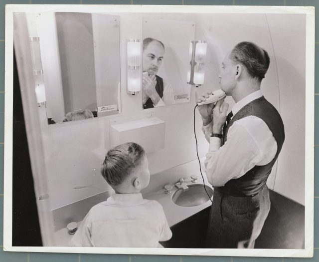 Man and young boy aboard Boeing Stratocruiser 