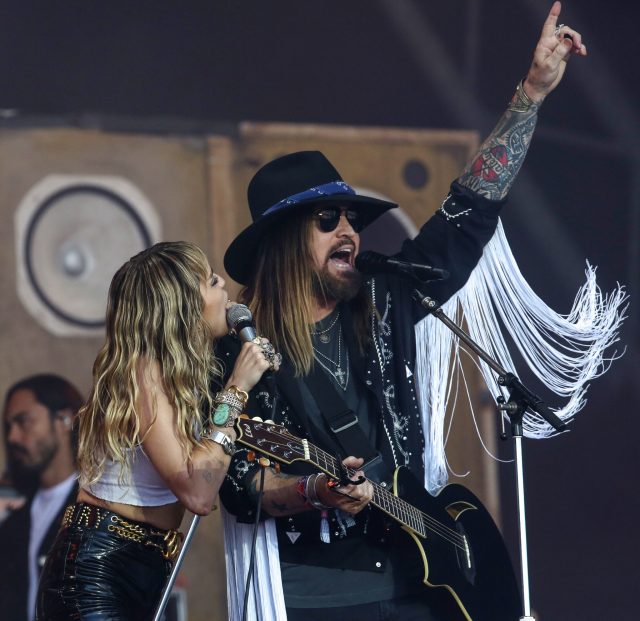 Miley Cyrus and Billy Ray Cyrus performing 