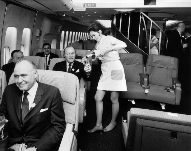 Flight attendant serving alcohol 