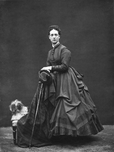 Alexandra, Princess of Wales, standing beside a dog