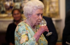 The queen taking a sip of water