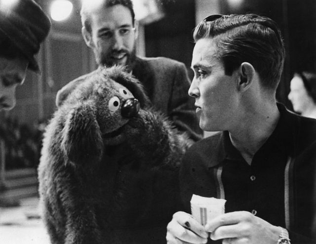 Muppets creator Jim Henson, (beard, background), manipulates one of his creations as it engages in conversation with singer Jimmy Dean in 1963. (Photo by Michael Ochs Archives/Getty Images)