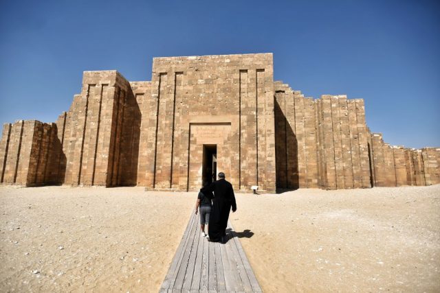 Two individuals walking toward the Southern Tomb of King Djoser