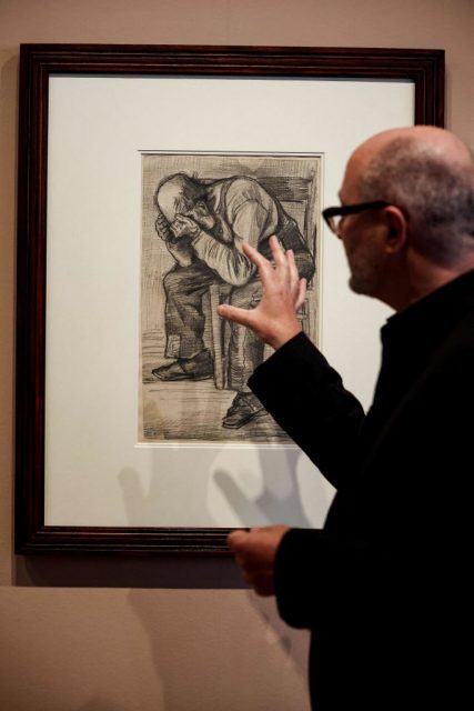 Man extending his hand toward Study of Worn Out