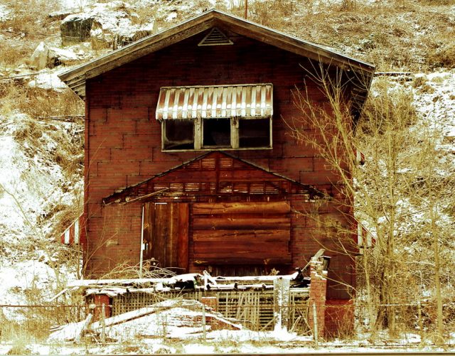 Derelict building covered in snow