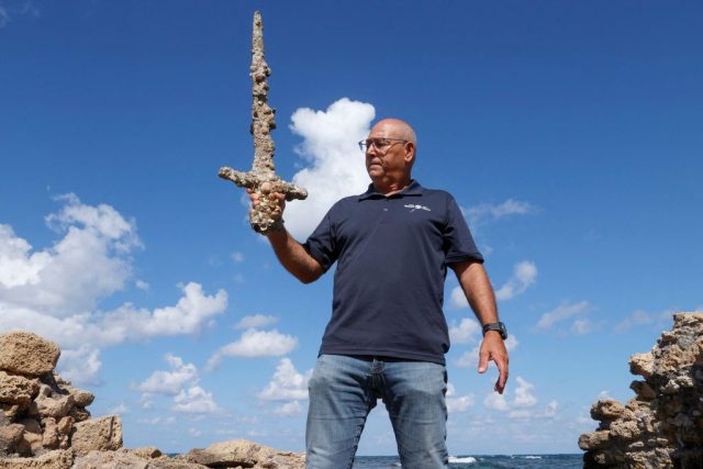 Man holding the Crusades sword with one hand