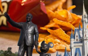 Walt Disney figurine in front of a pile of Doritos