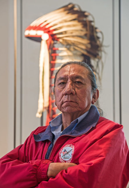 Ernie LaPointe, great-grandson of the legedary chief ‘Sitting Bull,’ stands in front of the war bonnet from chief ‘Red Eagle’ at the Uebersee Museum Bremen in Bremen, Germany, 03 November 2016 (Photo Credit: Ingo Wagner/picture alliance via Getty Images)