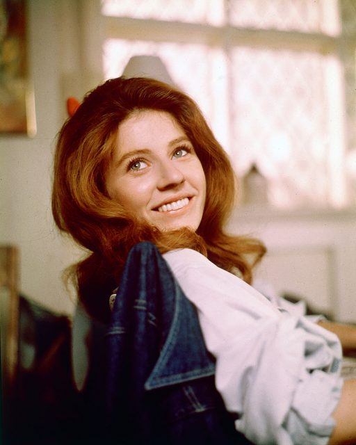 Patty Duke, smiling as she turns her head toward the camera for a portrait, while sitting in a chair with a denim jacket on the backrest, circa 1970. (Photo Credit: Silver Screen Collection/Getty Images)