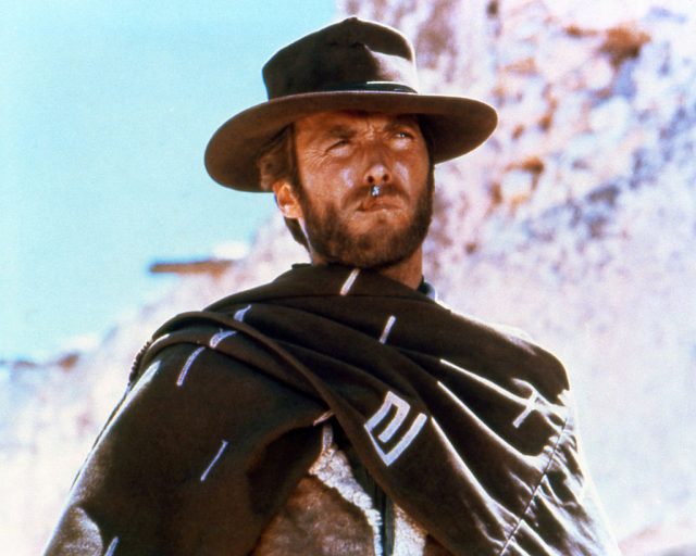 Clint Eastwood, US actor, smoking a cigar, wearing a brown hat and poncho in a publicity portrait issued for the film, ‘A Fistful of Dollars’, Spain, 1964. (Photo Credit: Silver Screen Collection/Getty Images)