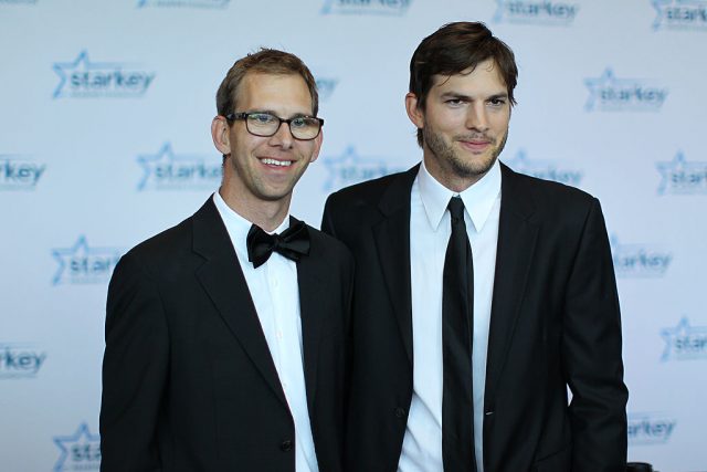 Michael Kutcher and brother Ashton Kutcher walk the red carpet before the 2013 Starkey Hearing Foundation’s “So the World May Hear” Awards Gala (Photo Credit: Adam Bettcher/Getty Images for Starkey Hearing Foundation)