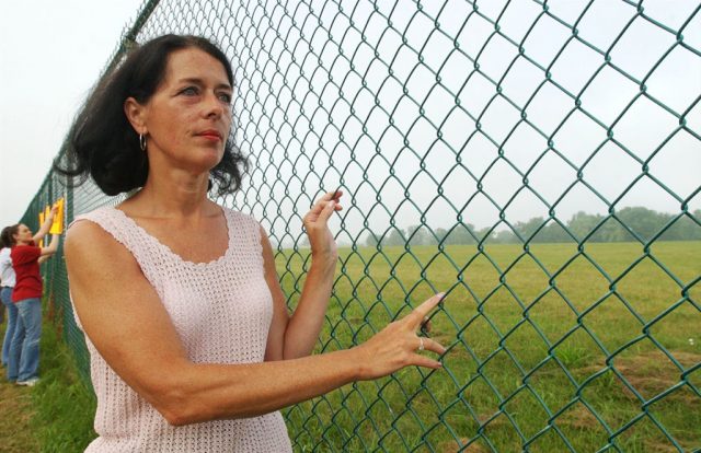 Lois Gibbs, a former resident and community leader, looks at Love Canal during a commemoration of the 25th Anniversary of the toxic waste landfill August 1, 2003 in Niagara Falls, New York. Love Canal was America’s most notorious toxic dump (Photo Credit Harry Scull Jr./Getty Images)