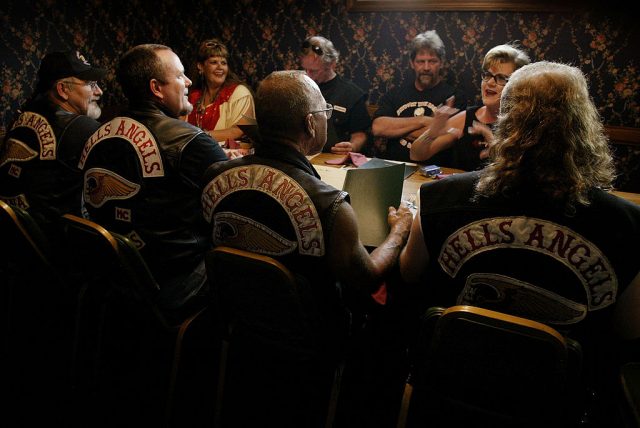 Members of the Hells Angels motorcycle club, with wives and friends, order dinner at a restaurant August 23, 2003 in Quincy, Illinois. The motorcycle club was in Quincy for a book signing event and party honoring Sonny Barger (2nd-R/back to camera), founder of the Oakland, California charter of the Hells Angels. (Photo Credit: Scott Olson/Getty Images)