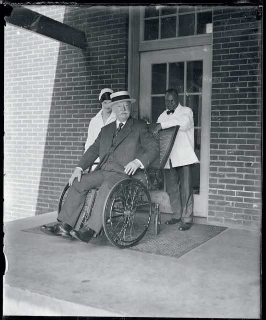 Taft leaves for Canadian home…Chief Justice Taft, photographed just before he and Mrs. Taft boarded the train at the Union Station in Washington for their summer home at Murray Bay, Canada. Mr. Taft has been confined for several days rest at the Garfield Memorial Hospital in Washington. (Photo Credit: