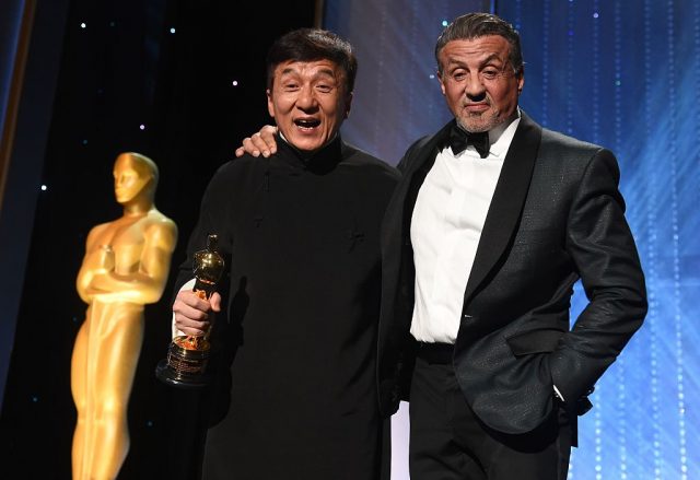 Honoree Jackie Chan (L) poses with actor Sylvester Stallone after Chan accepted his Honorary Oscar Award (Photo Credit: ROBYN BECK/AFP via Getty Images)