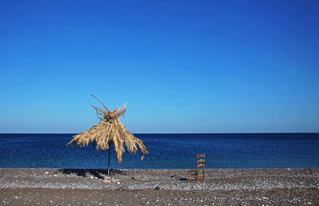 Empty chair on a beach (Photo Credit: EyesWideOpen/Getty Images)