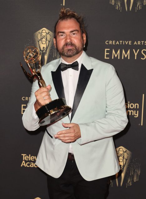 Marc Pilcher holding his Emmy Award