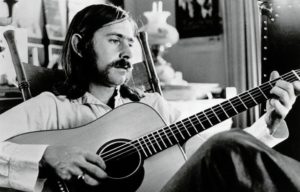Posed portrait of Norman Greenbaum with acoustic guitar