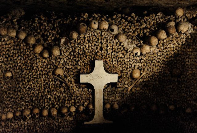 Cross surrounded by human skulls and femurs