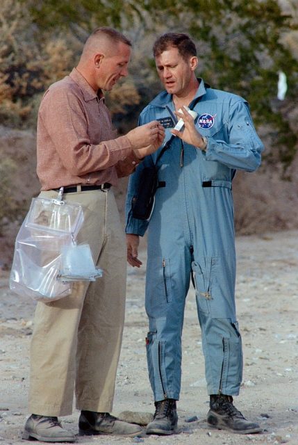 Jack Swigert and Bill Pogue standing together in the desert