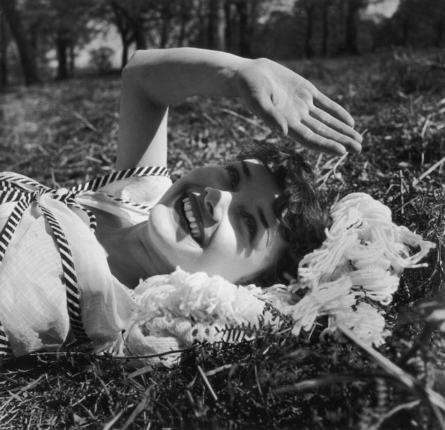 Audrey Hepburn using her hand to protect her eyes from the sun