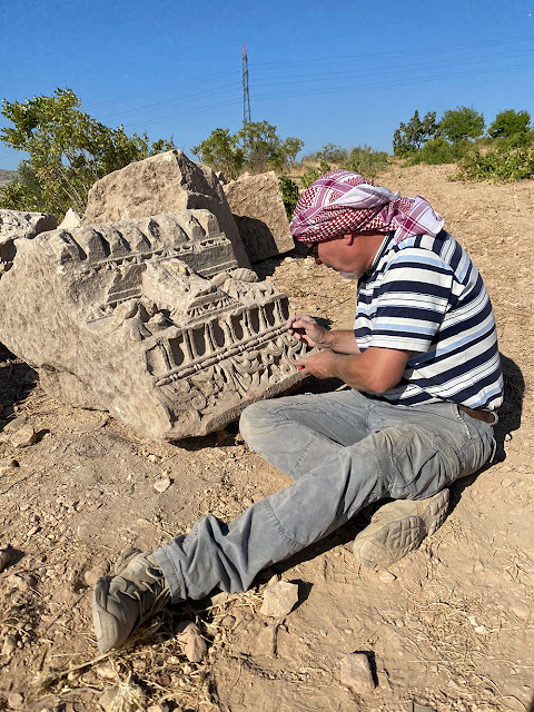 Man examining a piece of the Doliche temple