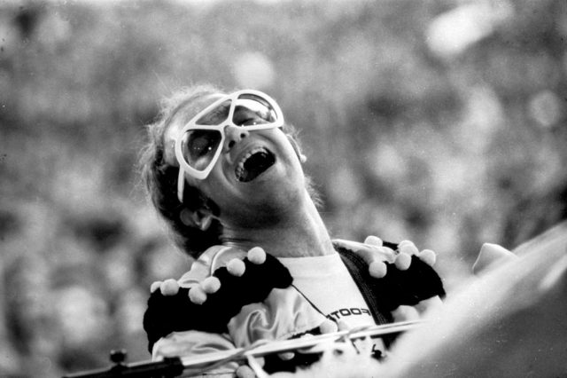 Elton John playing the piano