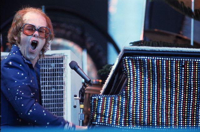 Elton John playing the piano