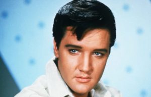 An iconic portrait of Elvis in front of a blue background