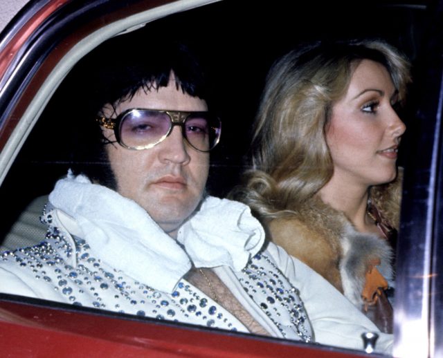 Elvis Presley and Linda Thompson sitting in the back of a car
