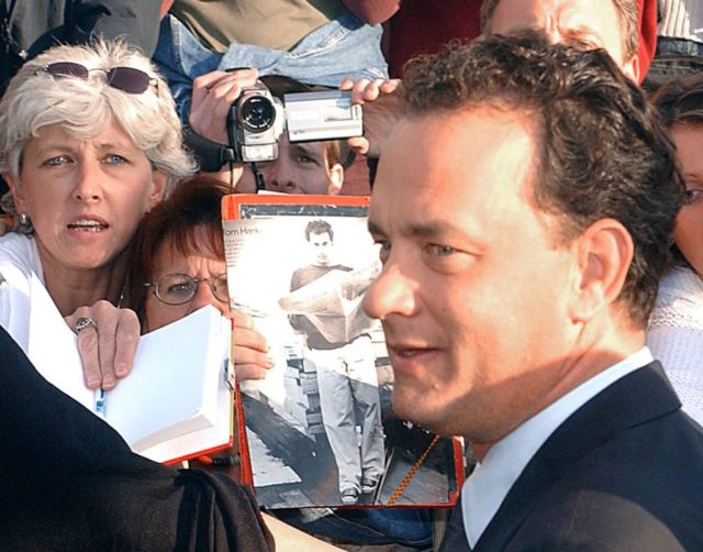 Tom Hanks posing with fans