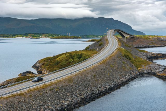 A sports car crossing the Storseisundet Bridge on the Romsdal Peninsula in western Norway. (Photo Credit: Rich Pearce/Total 911 Magazine via Getty Images via Getty Images)