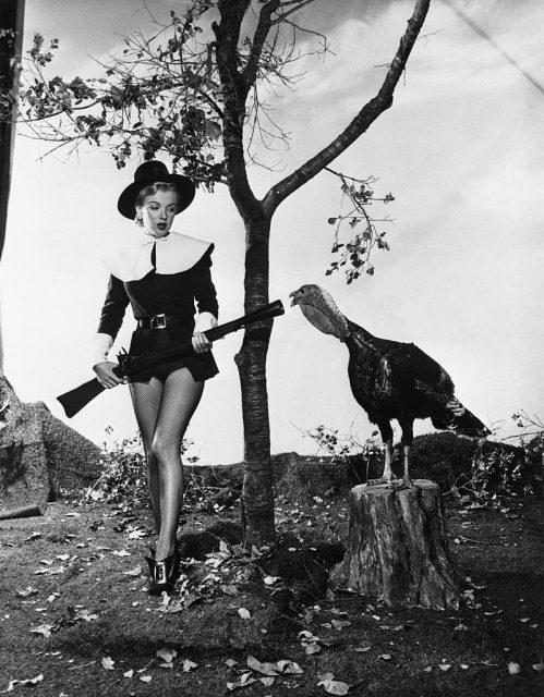 Marilyn Monroe dressed as a pilgrim, sneaking up on a turkey