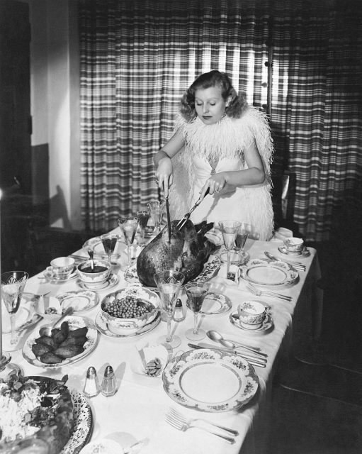 Lillian Harvey carving a turkey at the dinner table