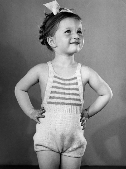 Fashion, knitwear fashion for children: – a little girl wearing a knitted swimsuit (Photo Credit: Atelier Blum/ullstein bild via Getty Images)